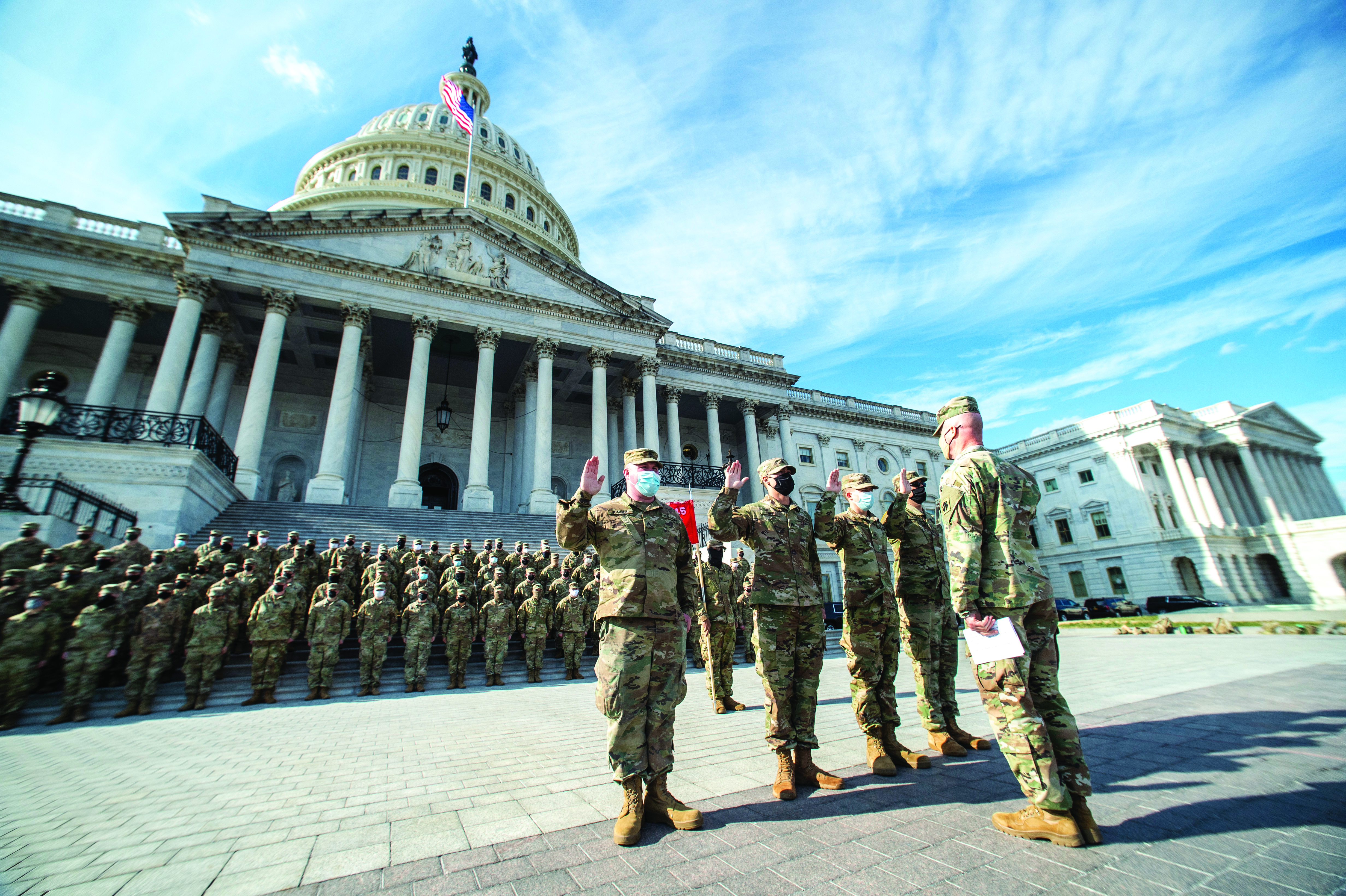 Members of the 545th Brigade Engineer Battalion, 45th Infantry Brigade Combat Team, Oklahoma Army National Guard, reenlist in front of the U.S. Capitol building
        in Washington, D.C., on 21 Jan. 2021. At least 25,000 National Guard men and women were authorized to conduct security, communication, and logistical missions
        in support of Federal and District authorities leading up to and through the 59th Presidential Inauguration. (Credit: Sergeant Anthony Jones)